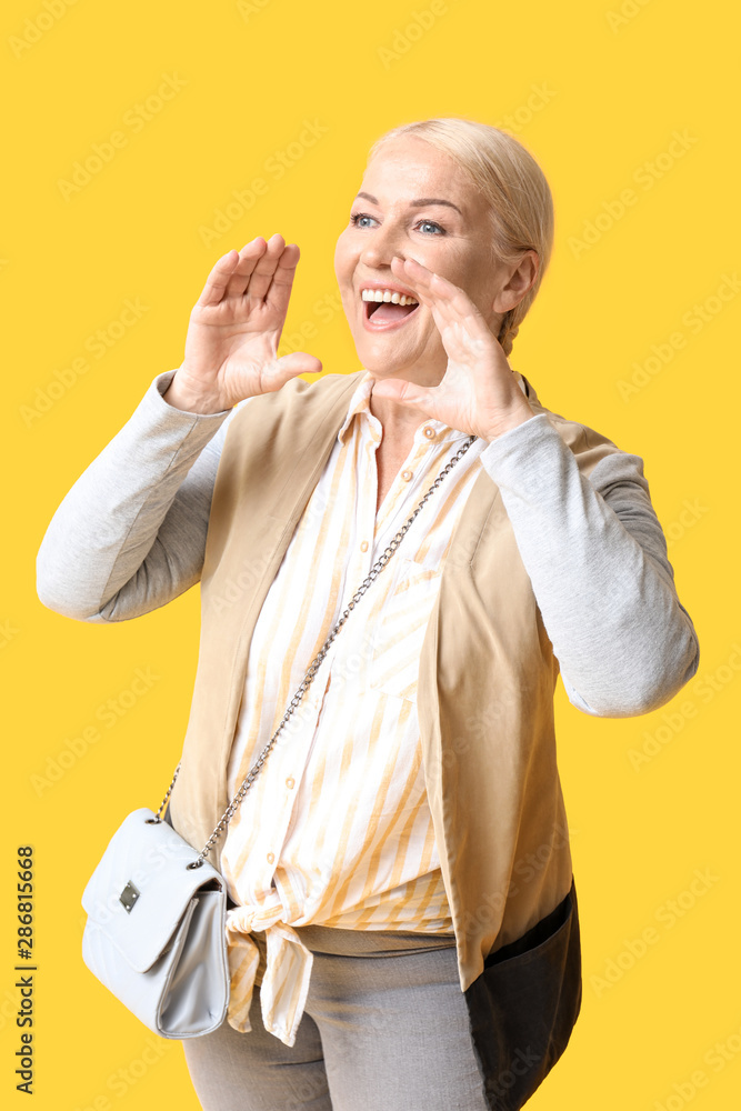 Screaming mature woman on color background