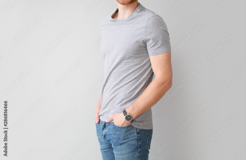 Man in stylish t-shirt on light background