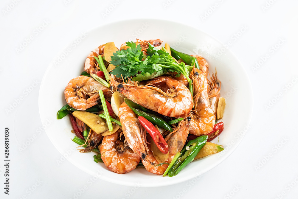 Chinese dish of spicy spicy black shrimp on white background