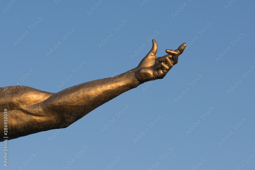 golden statue on blue sky