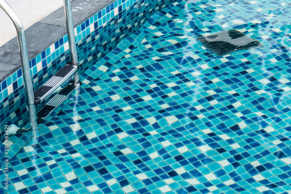 Ladder and  clear water pool. background concept for relaxation and tourist destination