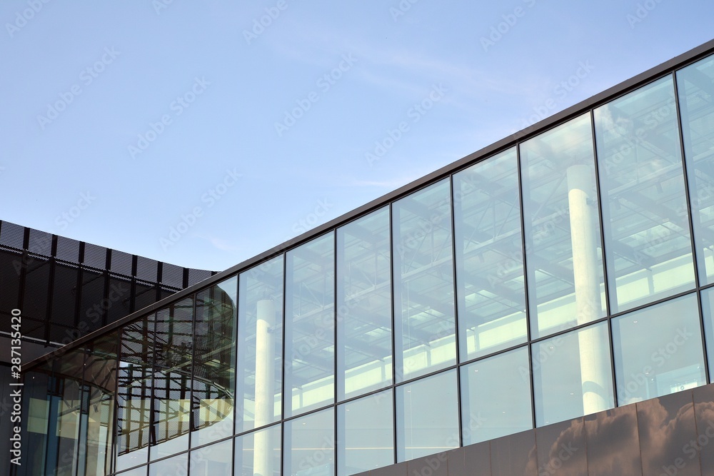 Facade fragment of a modern office building. Exterior of glass wall with abstract texture.