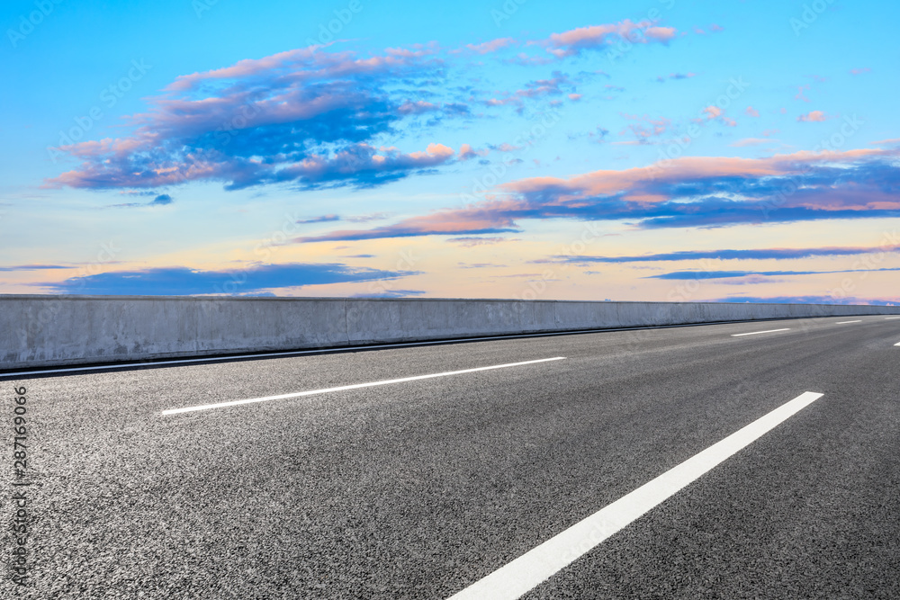 Empty asphalt highway and beautiful sky clouds at sunset