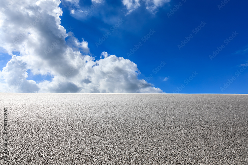 Asphalt highway road and blue sky with white clouds