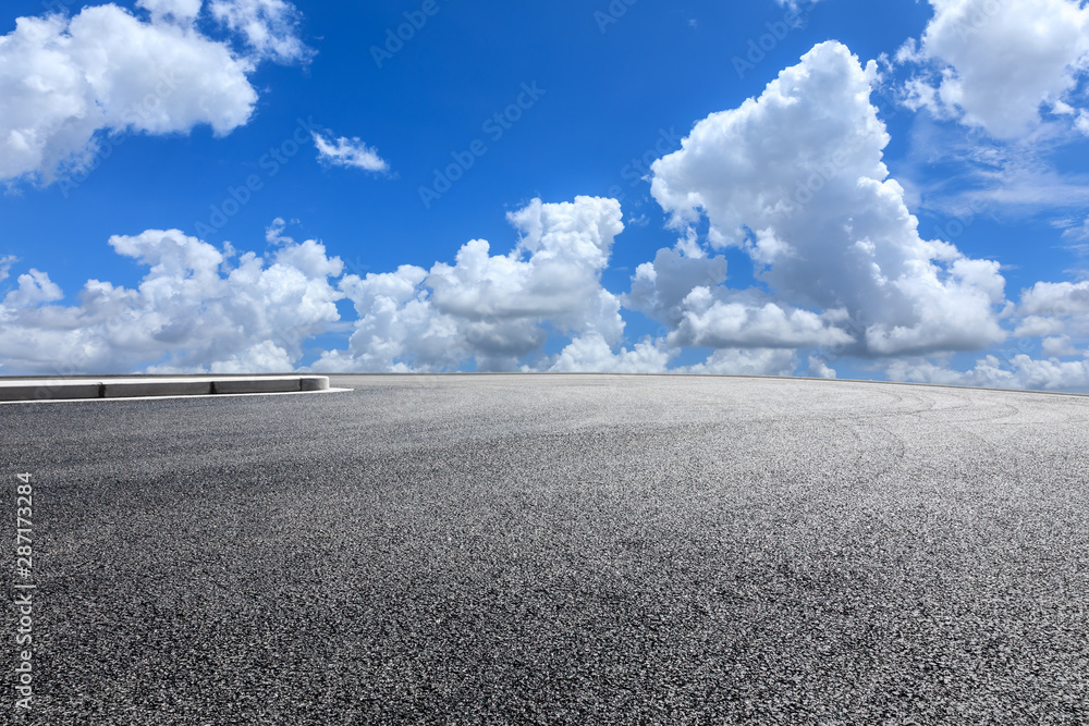 Empty race track road and blue sky with white clouds