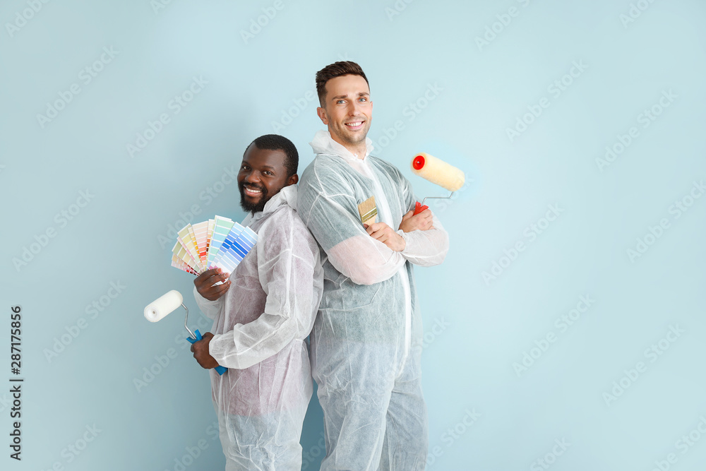 Male painters near color wall