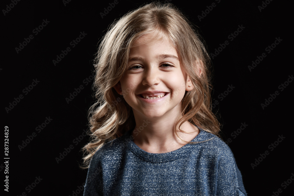 Cute happy girl on dark background