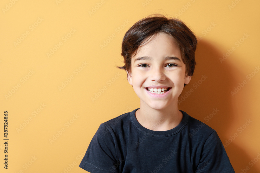 Cute little boy on color background