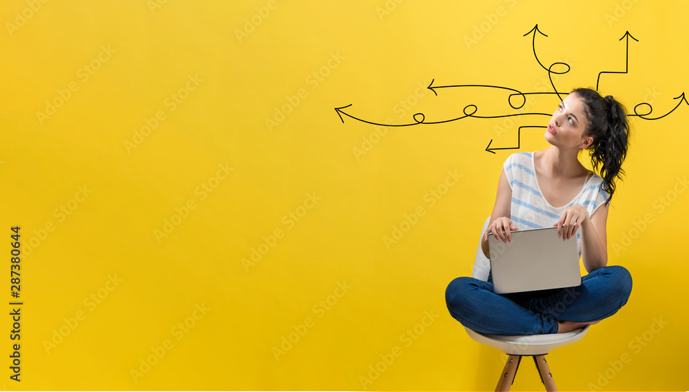 Idea arrows with young woman using a laptop computer