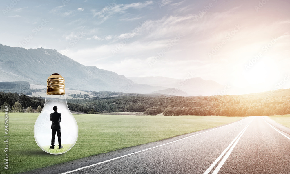 Businessman inside light bulb