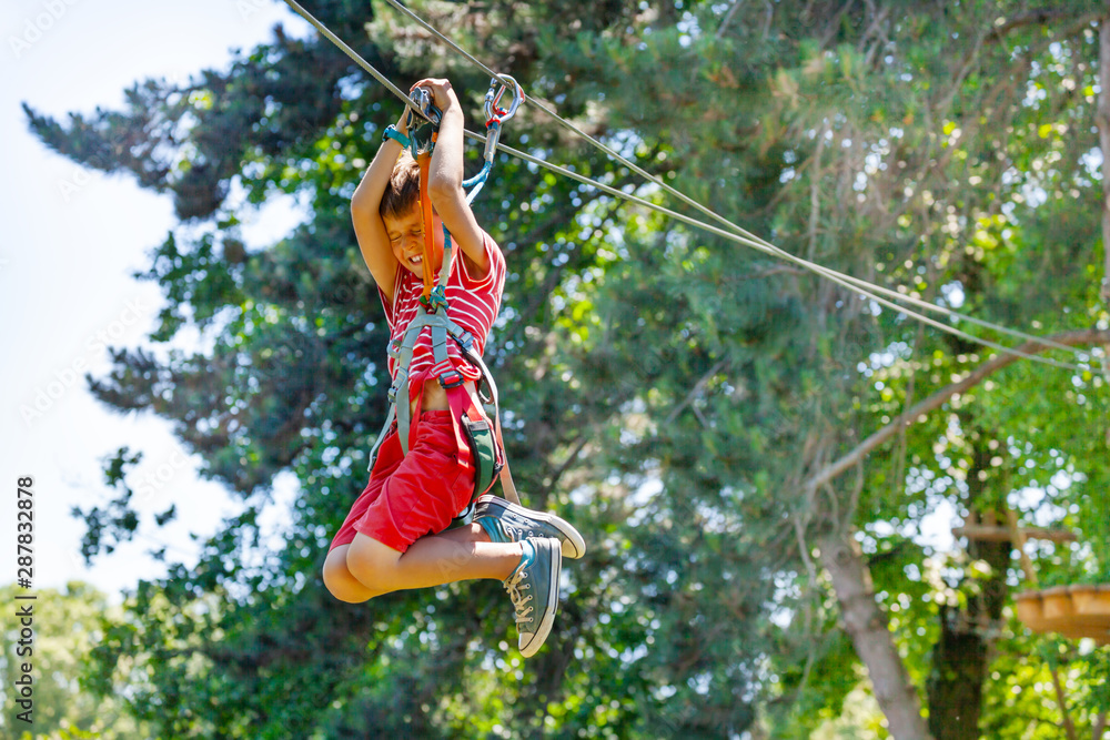 Boy scream and fast slide zip line with trolley