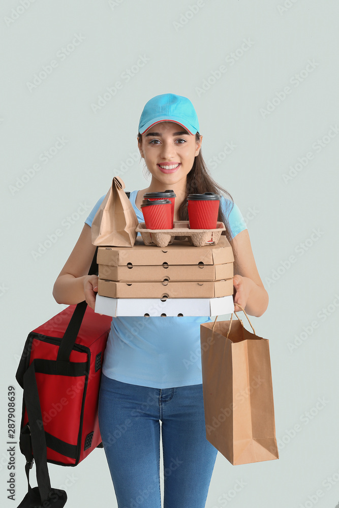 Female worker of food delivery service on white background