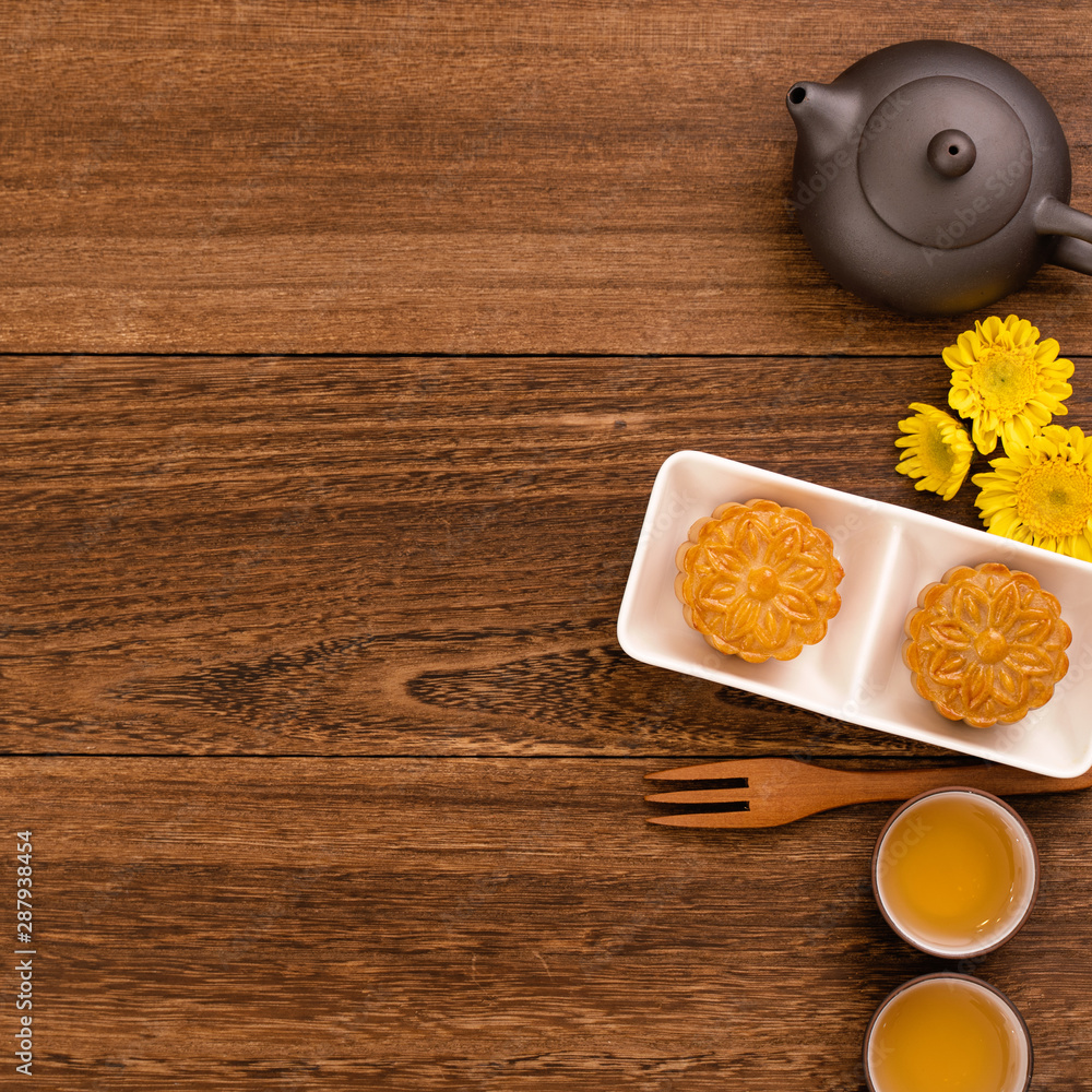 Mid-Autumn Festival holiday concept design of moon cake, mooncakes, tea set on dark wooden table wit