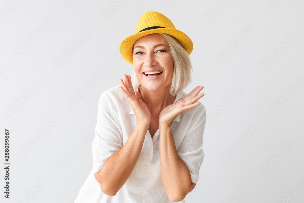 Stylish mature woman on light background