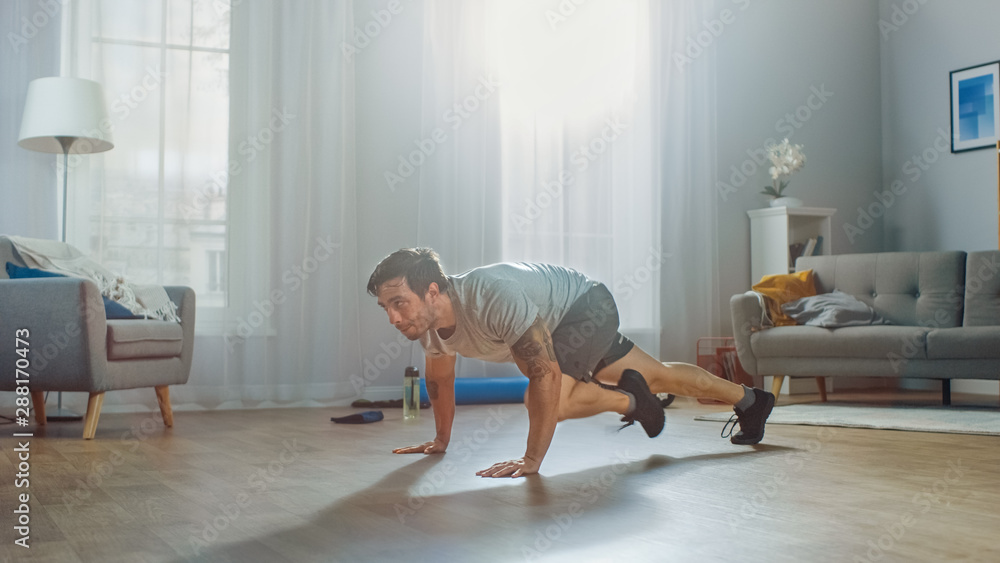 Muscular Athletic Fit Man in T-shirt and Shorts Energetically Starts Doing Mountain Climber Exercise