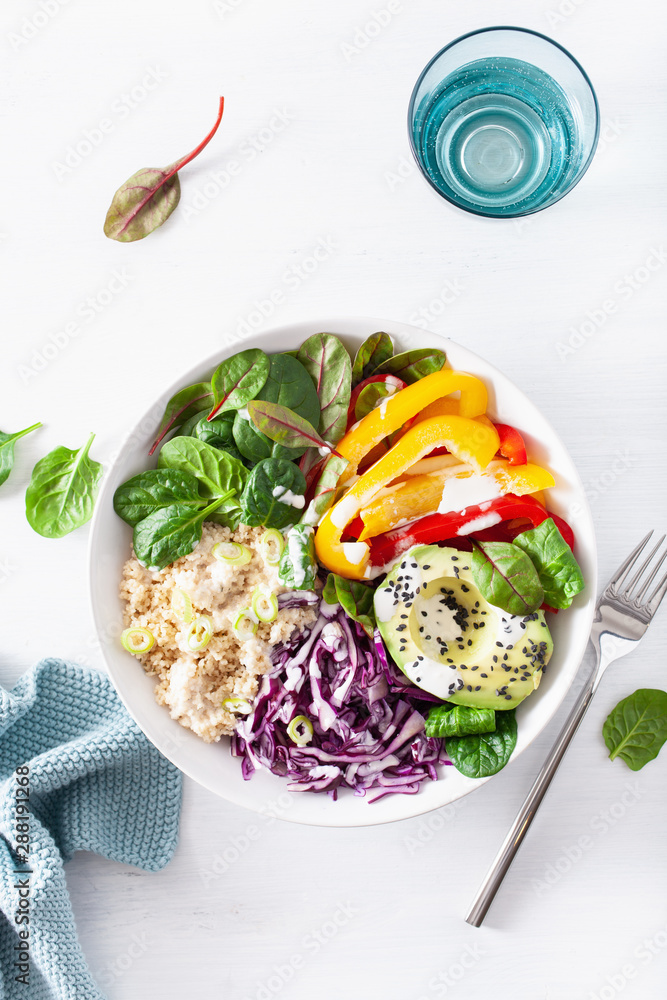 veggie couscous lunch bowl with avocado, bell peppers, spinach and red cabbage