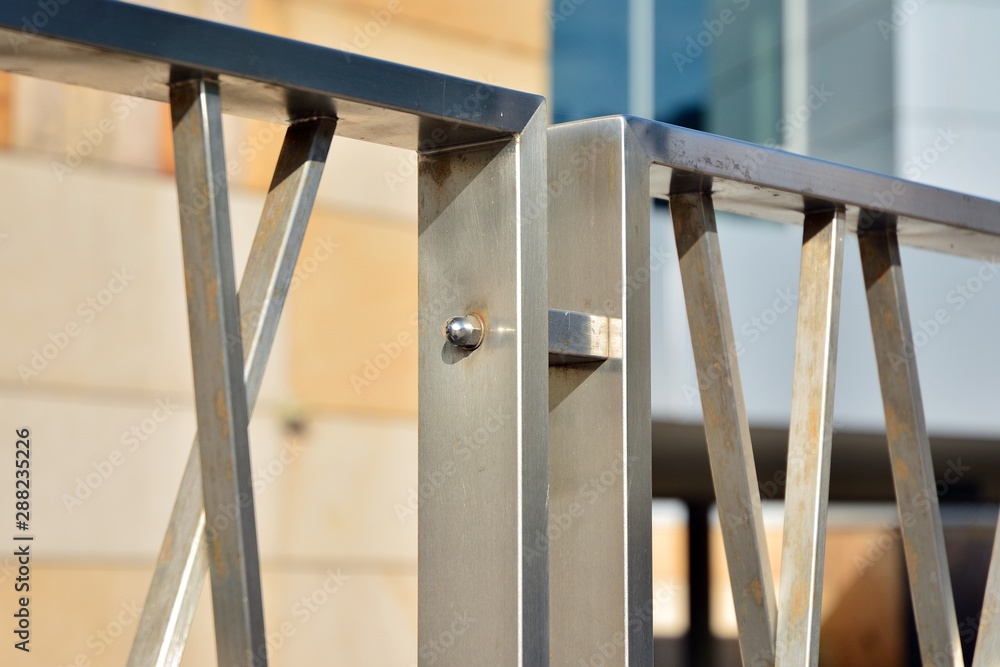 Chromium metal fence with handrail. Chrome-plated metal railings. Shallow depth of field. Selective 