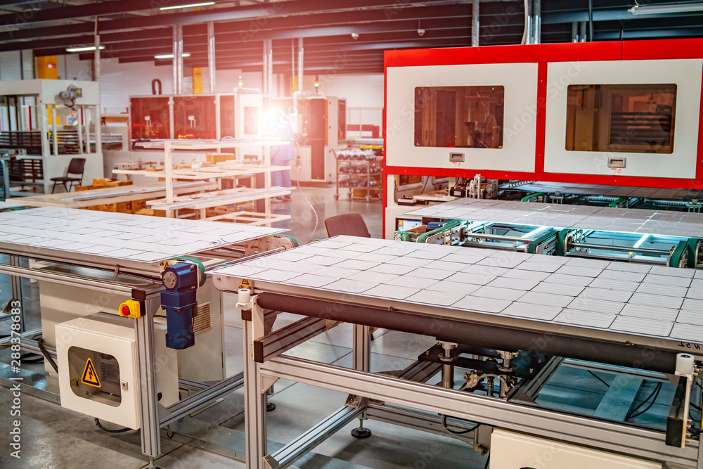 production of solar panels, man working in factory.