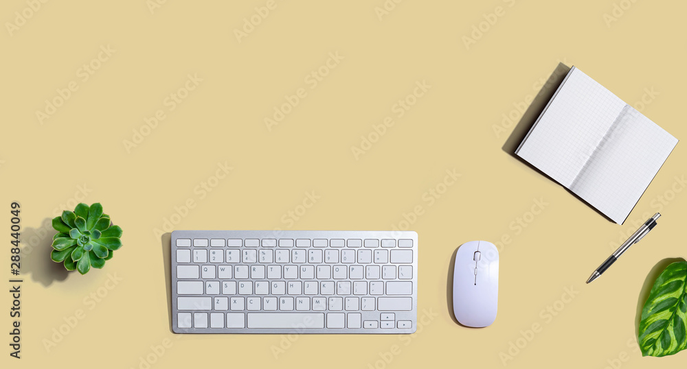 Computer keyboard and mouse with notebook from above