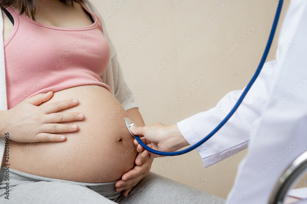 Happy pregnant woman visit gynecologist doctor at hospital or medical clinic for pregnancy consultan