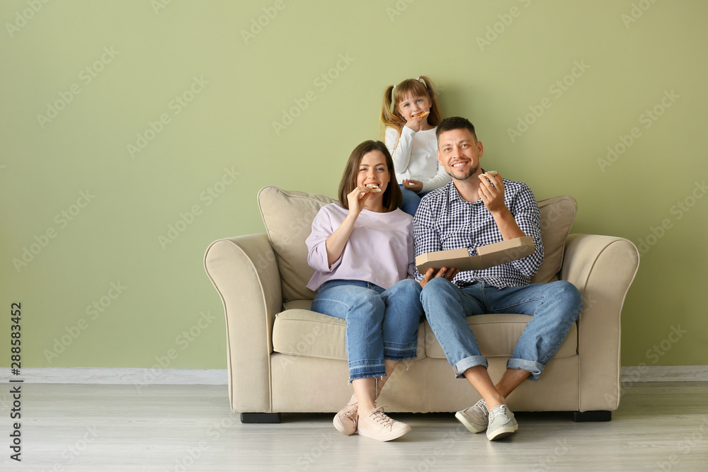 Happy family eating pizza at home