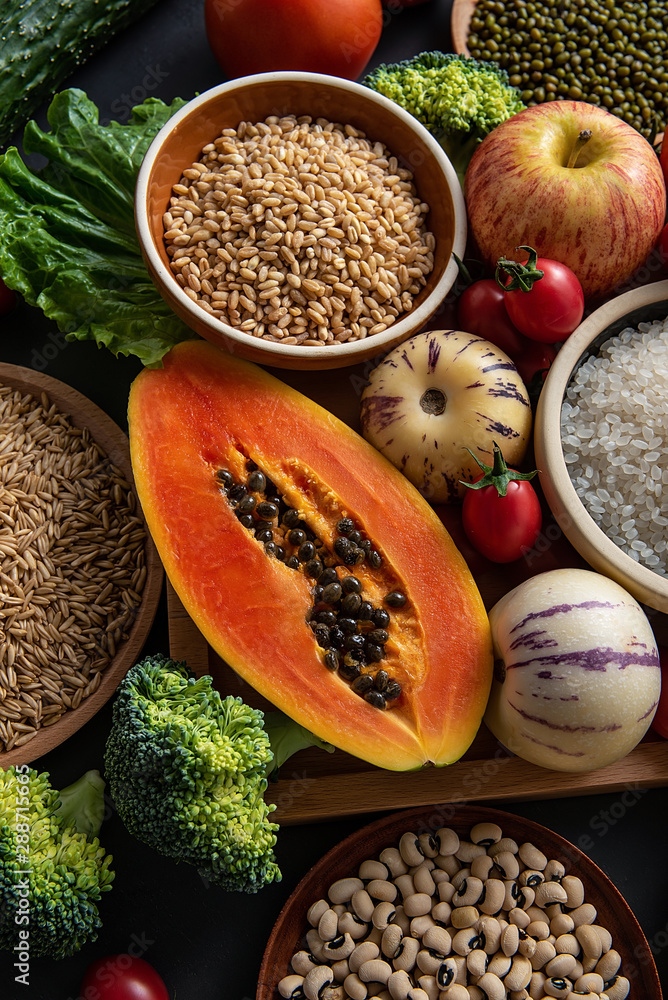 Full screen of fresh seasonal fruits and vegetables and whole grains