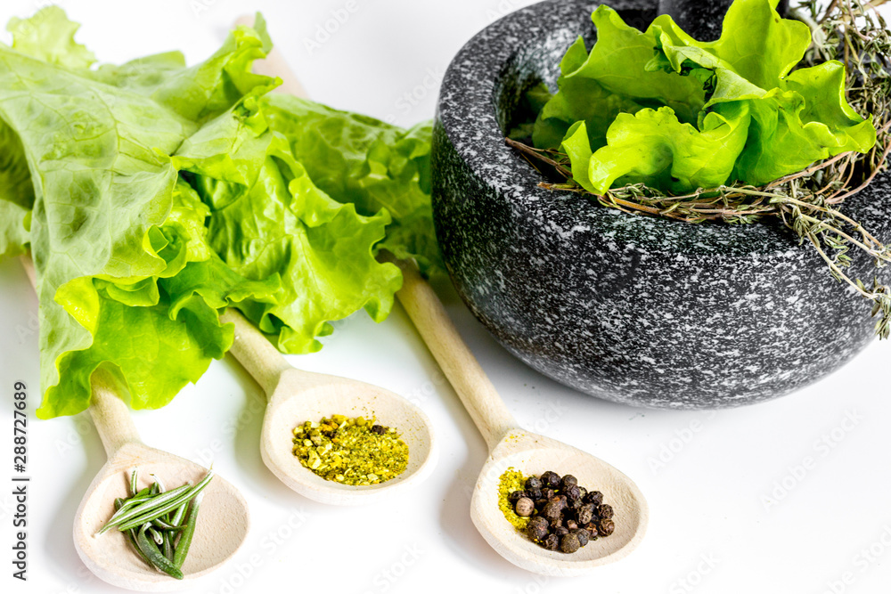 spices for cooking with pounder on white background close up