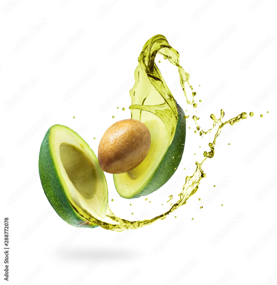 Sliced avocado with splashes isolated on white background