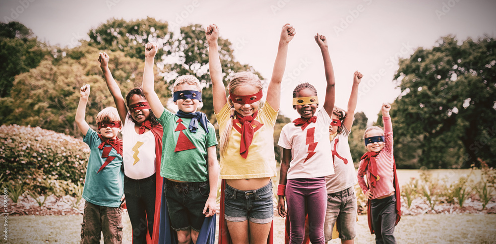 Children wearing superhero costume standing