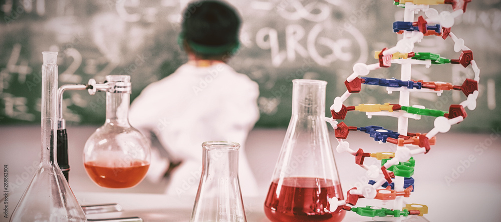 Chemicals beaker and flasks n table in laboratory