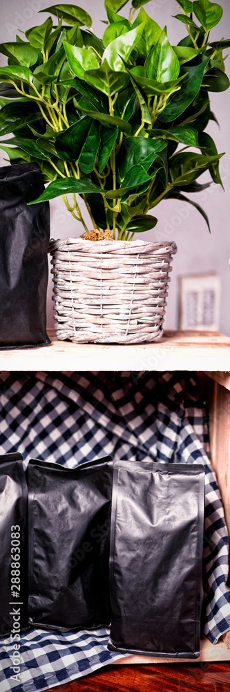 Coffee bags and pot plant on wooden table