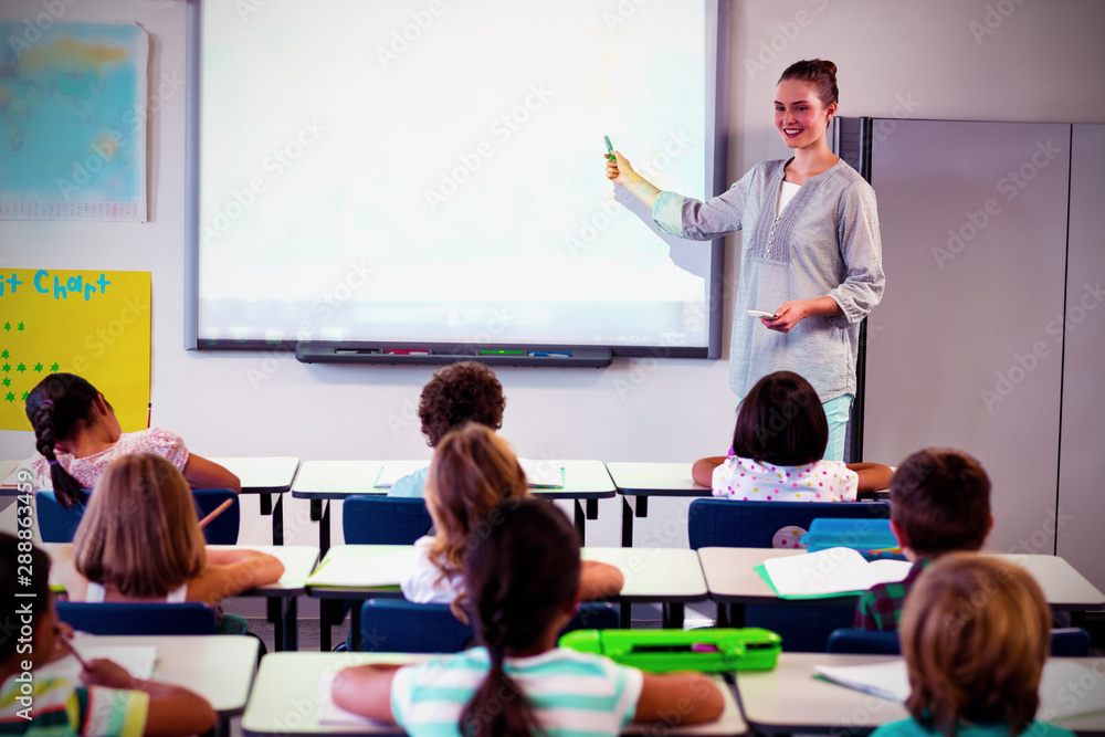 Teacher teaching children using projector 