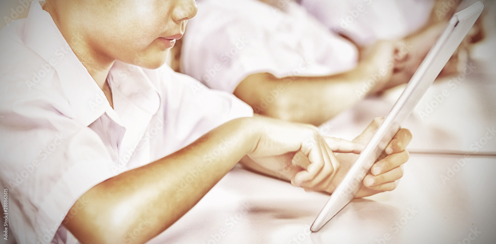 Kids using digital tablet in classroom