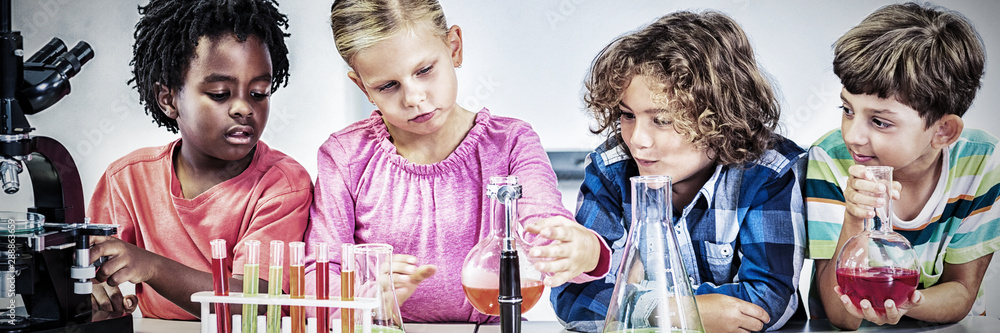 Kids doing a chemical experiment in laboratory