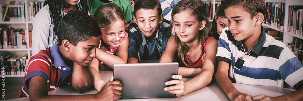 Front view of pupils using tablet pc