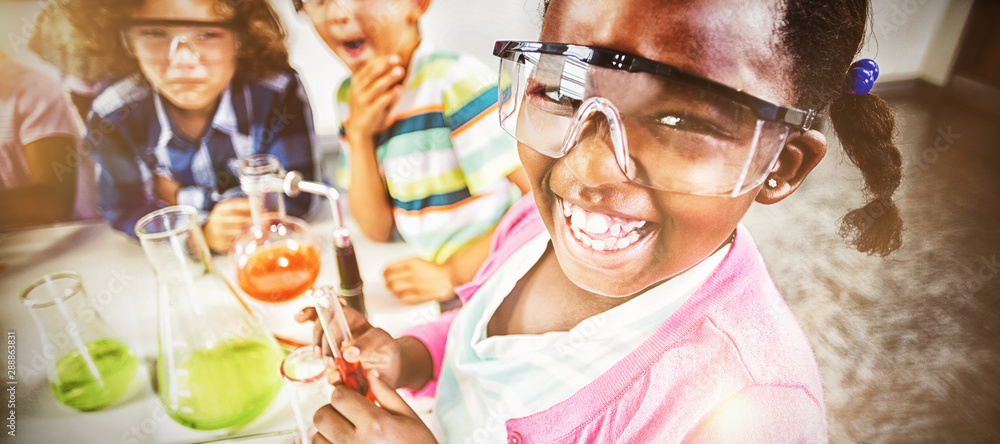 Kids doing a chemical experiment in laboratory