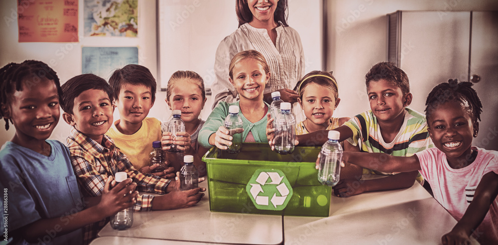 Portrait of pupils and teacher recycling 