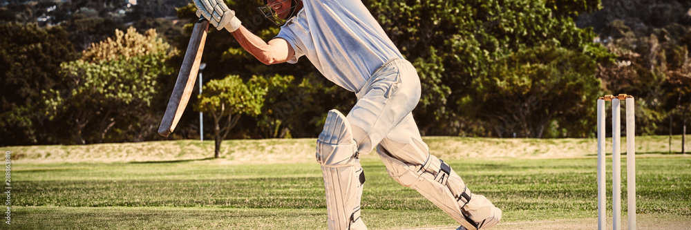 Full length of cricketer playing on field