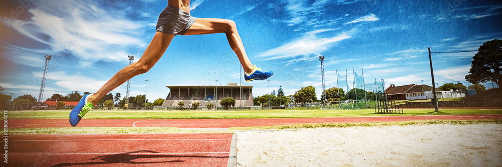 Female athlete performing a long jump