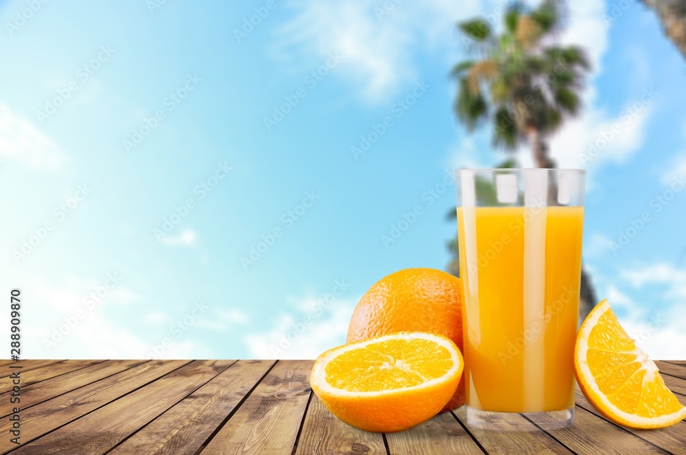 Orange juice and slices of orange on background