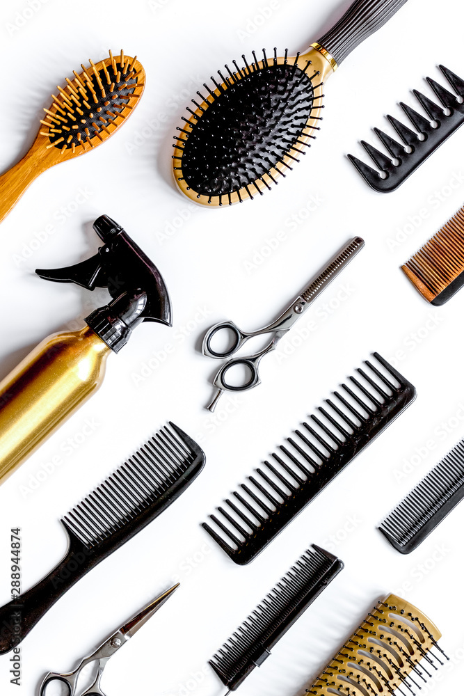 combs and hairdresser tools on white background top view