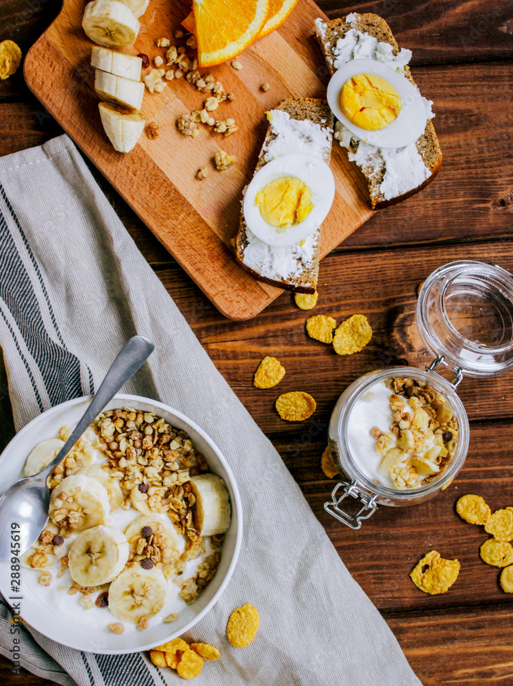 healthy breakfast bowl of yogurt with granola and eggs