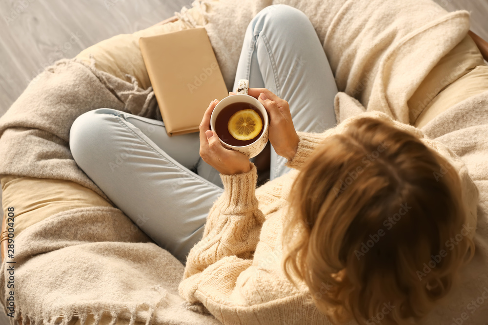 Young woman drinking hot tea at home