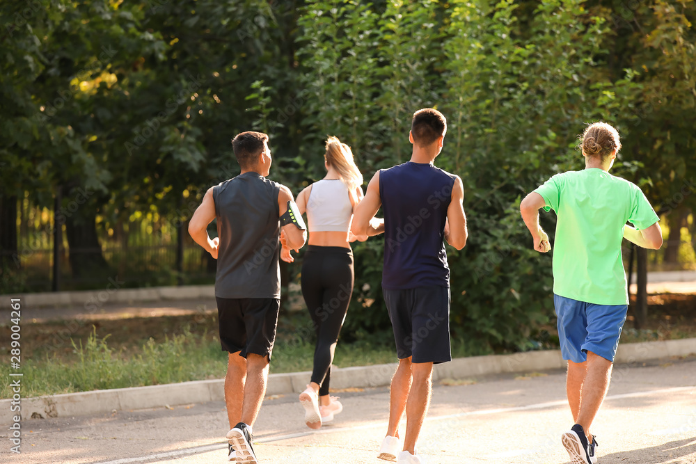 Group of sporty young people running outdoors