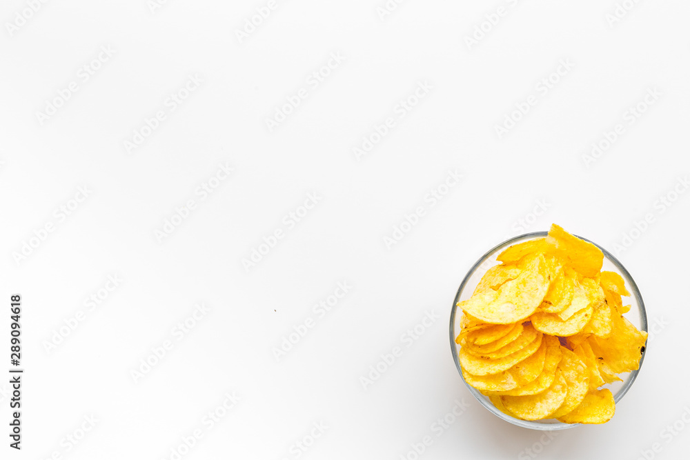 Junk food concept with heap of potato crisps on white background top view space for text