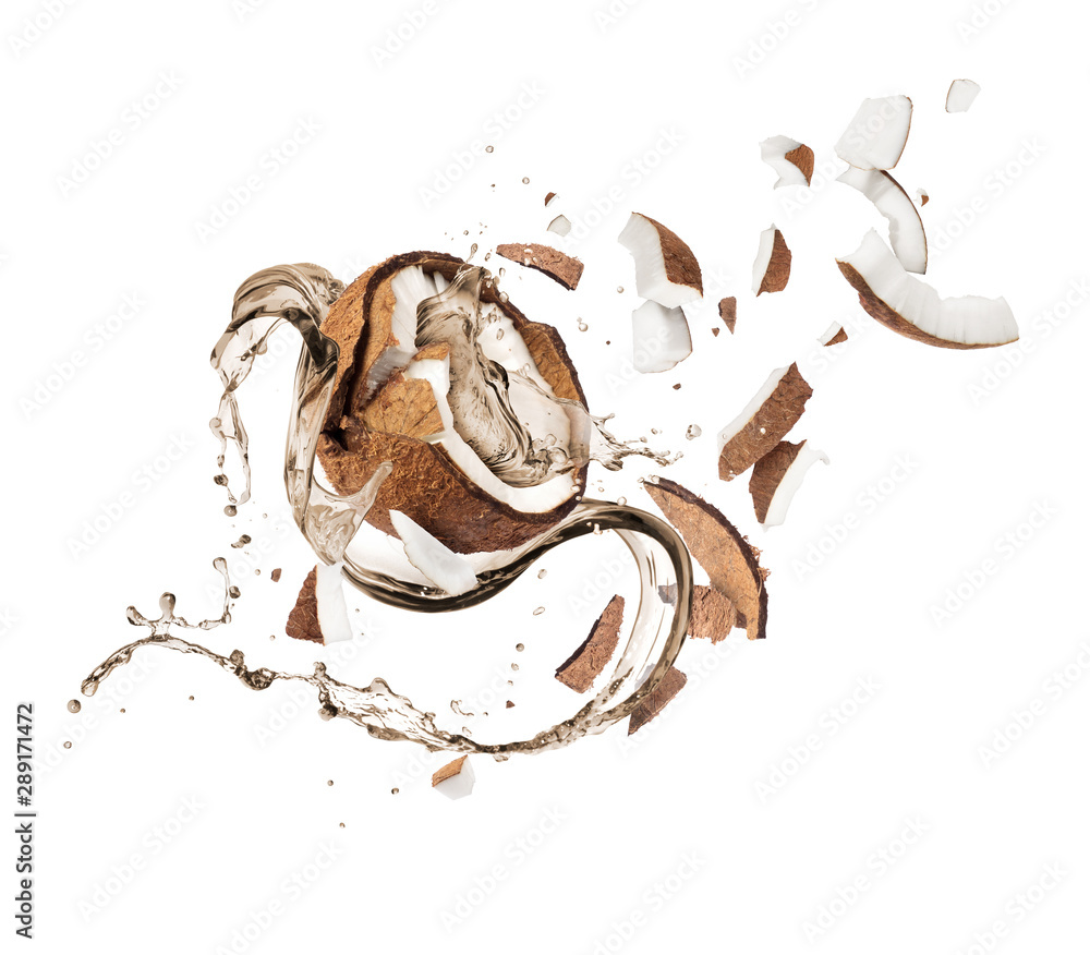 Broken coconut with with splashes of juice, isolated on white background.