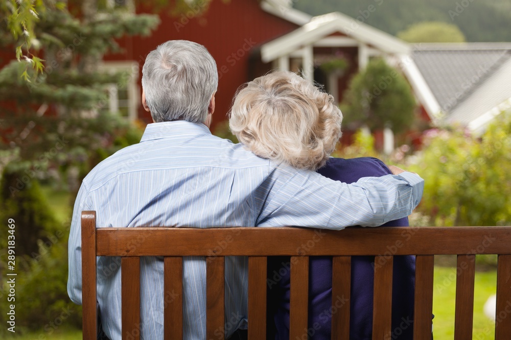 Portrait of happy senior couple in green