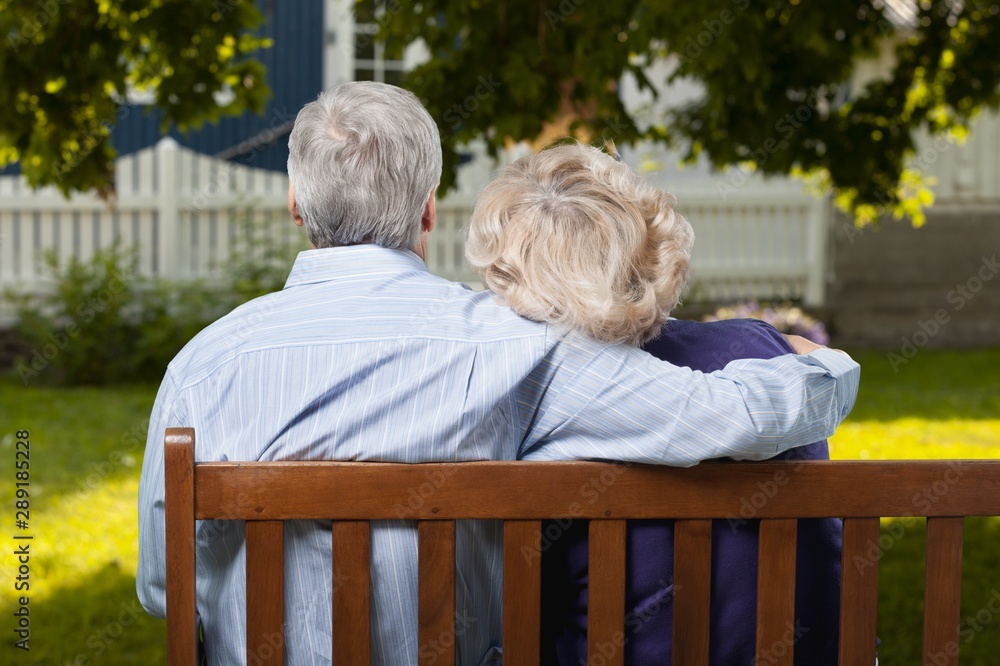 Portrait of happy senior couple in green