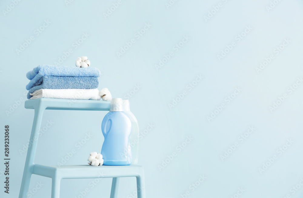 Stand with clean towels and washing agents near color wall