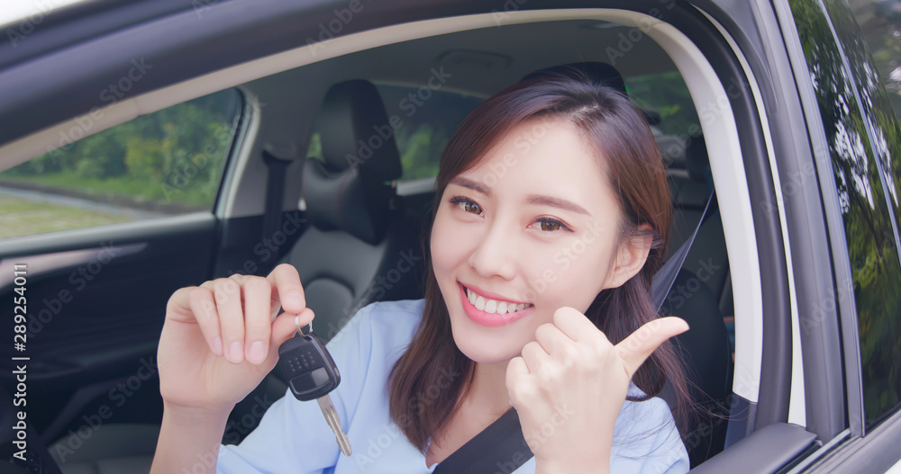 Asian woman hold car key